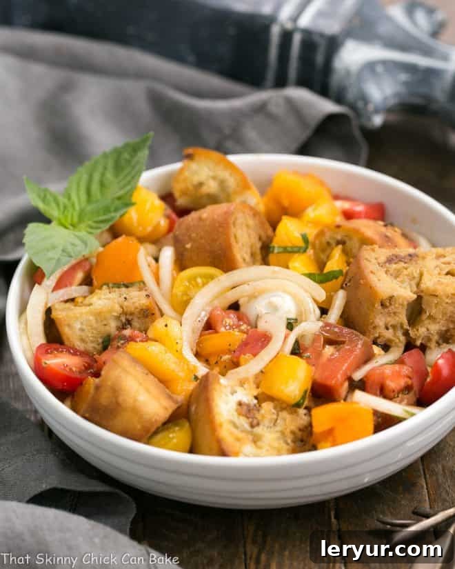 Sun-Drenched Tomato and Creamy Burrata Panzanella 3 A vibrant Summer Tomato and Burrata Panzanella Salad artfully arranged in a white ceramic bowl, showcasing its rustic elegance and fresh ingredients.