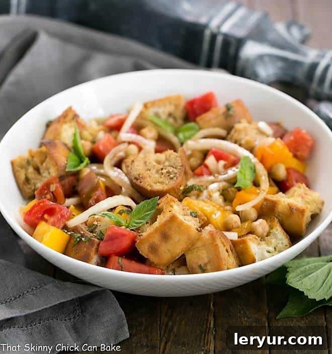 Summer Tomato and Burrata Panzanella Salad in a white ceramic serving bowl