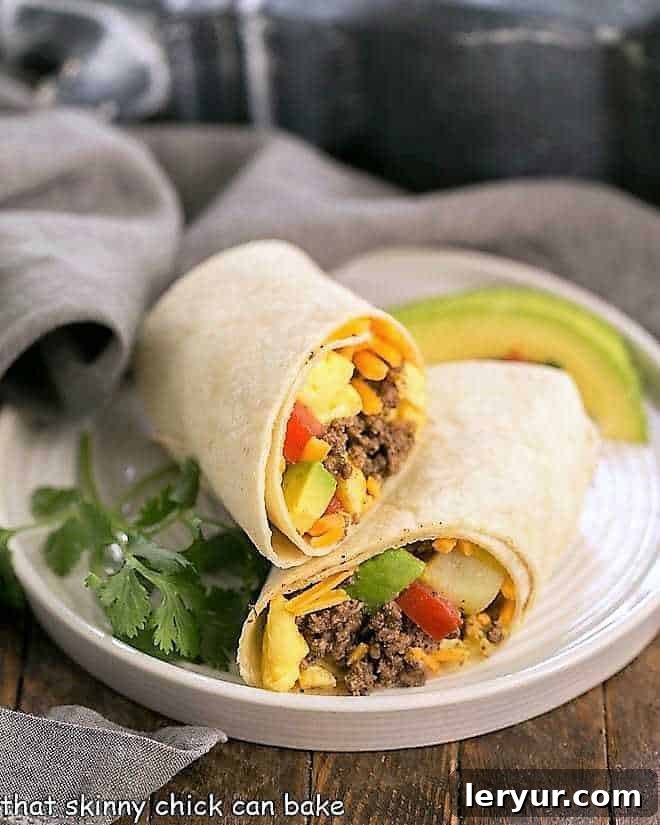 Tex-Mex Breakfast Burritos on a white plate with cilantro and avocados.