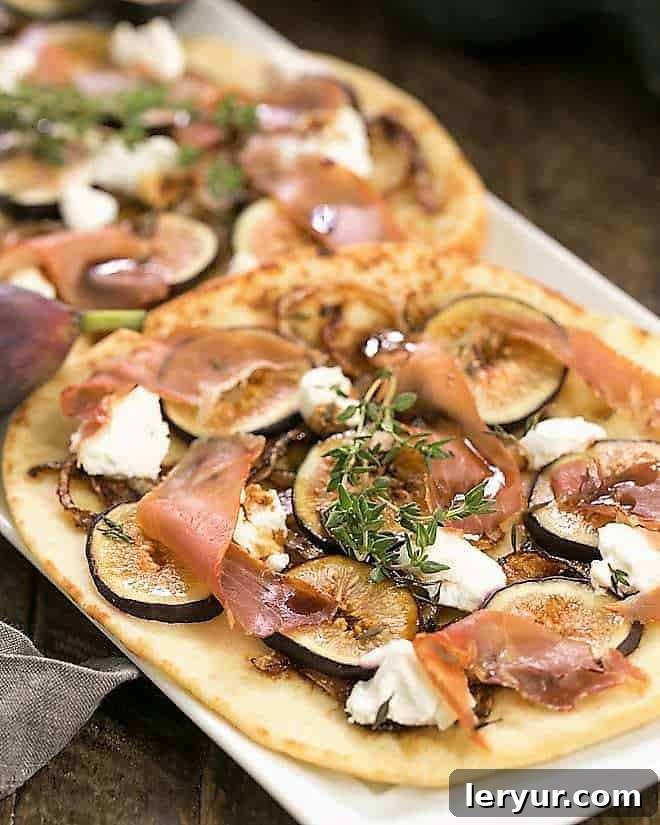 Fig, Goat Cheese and Prosciutto Pizza - fig pizzas are an elegant starter for all your entertaining needs while fresh figs are in season! Fig, Goat Cheese and Prosciutto Pizza on a white tray.