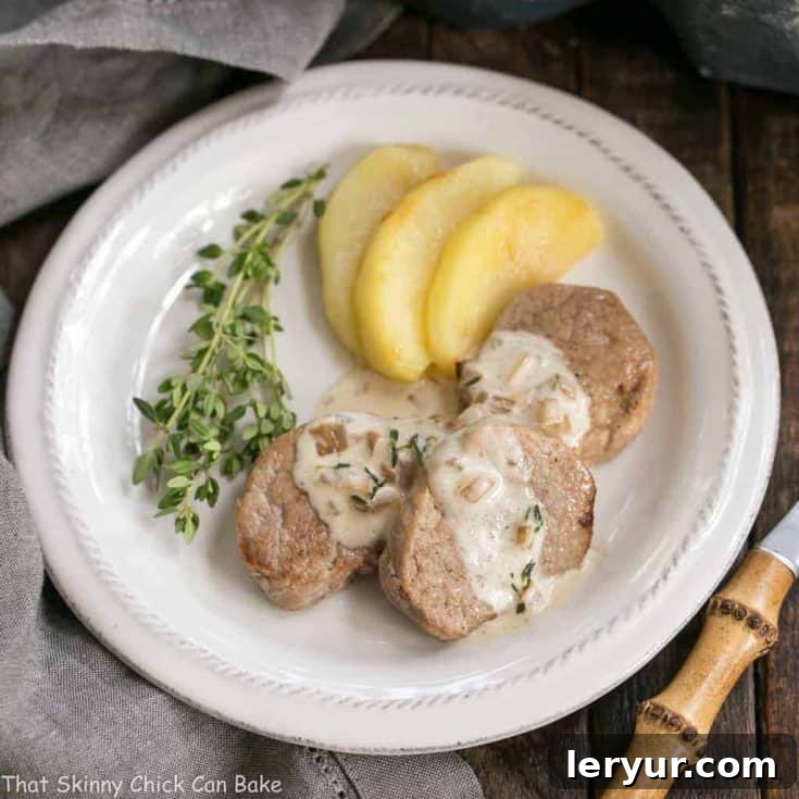 Gourmet Apple Topped Pork Medallions with a rich Calvados Cream Sauce, served for a restaurant-quality dinner.