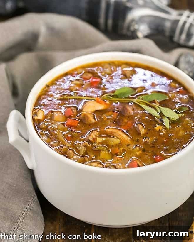 Sausage and Chicken Gumbo - a spicy, flavorful Cajun chicken stew that will warm you to your bones! Sausage and Chicken Gumbo in a white terrine
