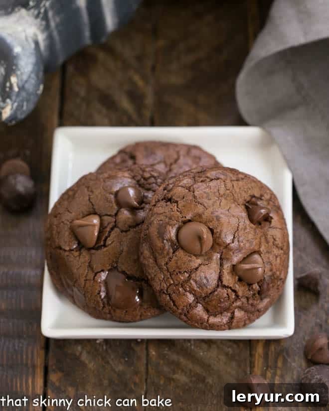 Death by Chocolate Cookies on a square white plate, perfectly baked with visible chocolate chips.