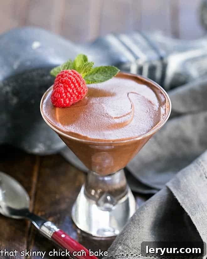 Chocolate Truffle Mousse AKA Mousse au Chocolat in a martini glass with a raspberry and mint.
