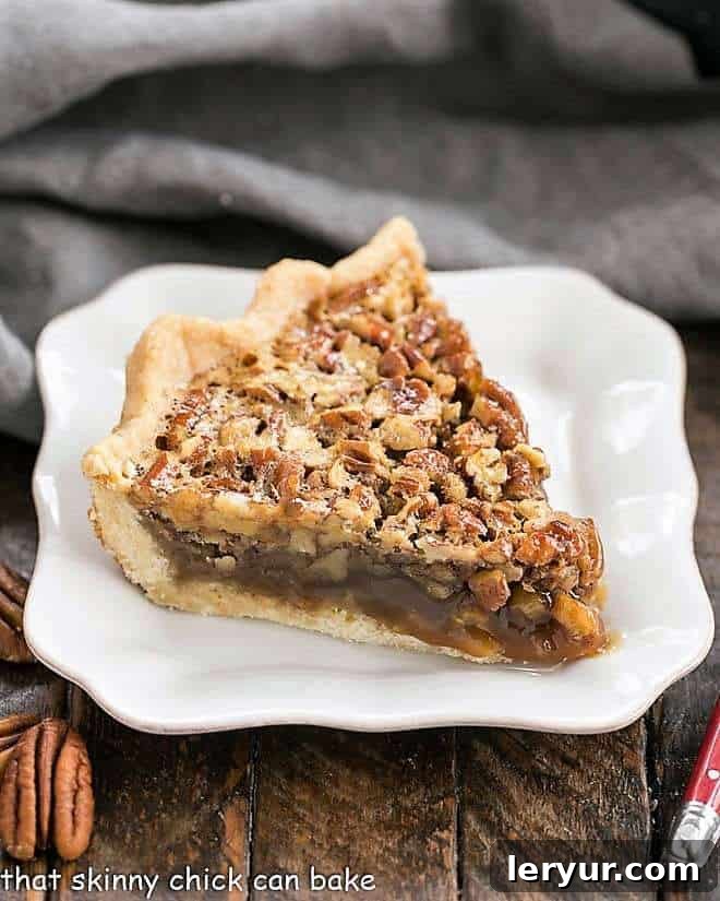 Classic Pecan Pie - a gooey, nutty, decadent holiday pie that is worth every calorie!! Classic Pecan Pie slice on a square white plate.