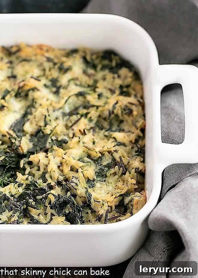 Cheesy Spinach Rice Casserole baked in a white baking dish.
