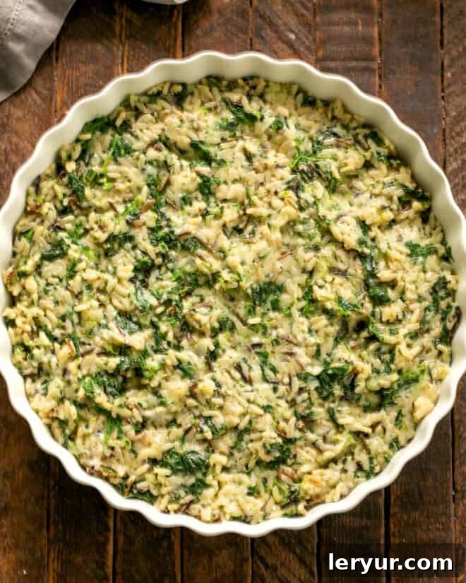 Ingredients for cheesy spinach rice casserole thoroughly mixed in a bowl.