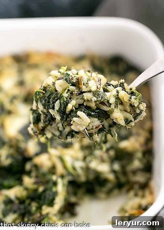 A spoonful of Cheesy Spinach Rice Casserole.