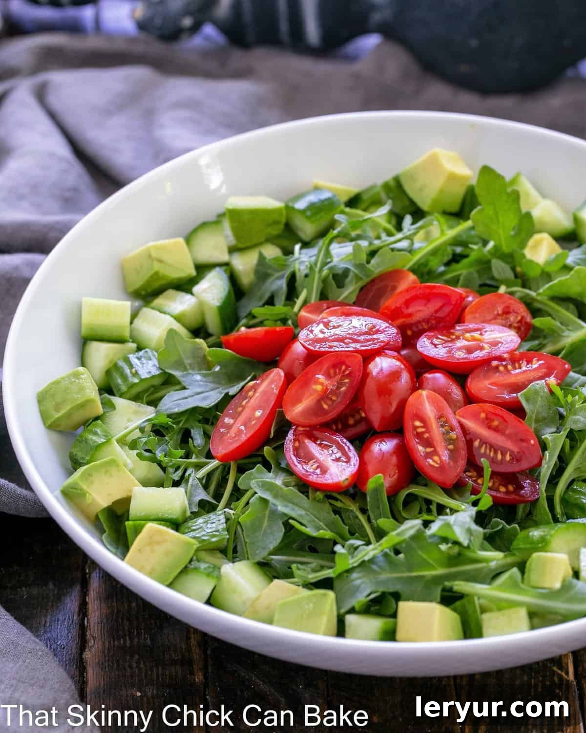 Bright Arugula Salad 2 Fresh rocket salad in a pristine white serving bowl, ready to be enjoyed.