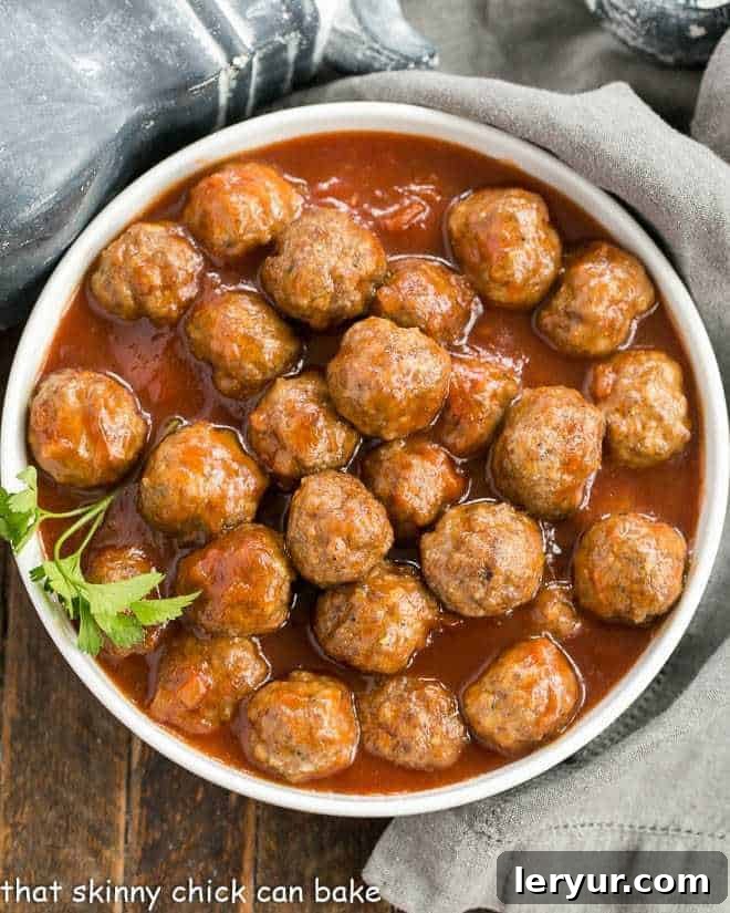Apricot Glazed Cocktail Meatballs - Delicious meatballs in a sweet and tangy sauce, perfect for all your entertaining needs Overhead view of apricot glazed cocktail meatballs in a white serving bowl