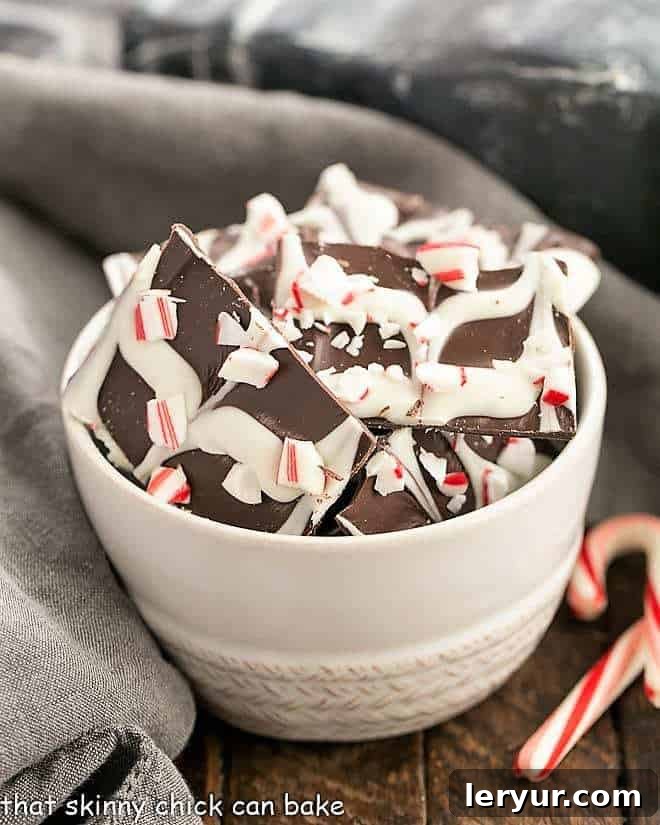 Swirled Peppermint Bark in a white bowl, showcasing the beautiful dark and white chocolate swirls with crushed candy canes.
