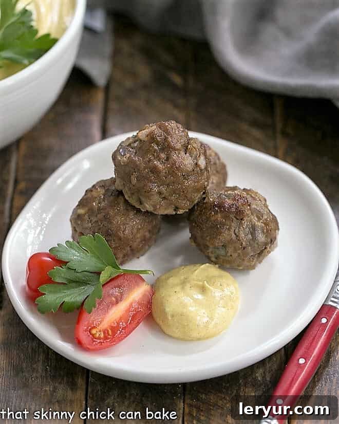Masala Meatballs with Raita 2 Three Indian meatballs artfully arranged on an appetizer plate with a dollop of creamy yogurt sauce