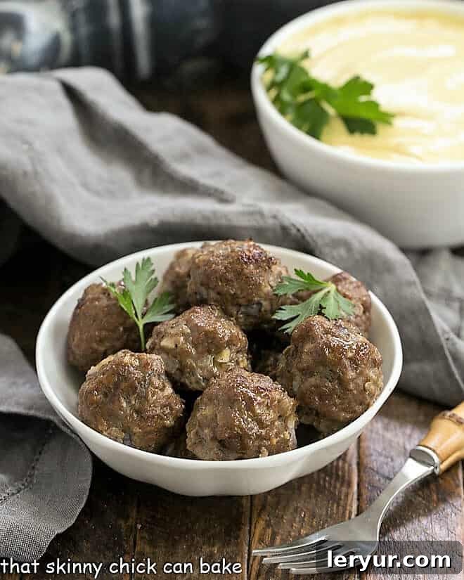Masala Meatballs with Raita 3 Grilled Beef Meatballs with Indian Yogurt Sauce in white bowls