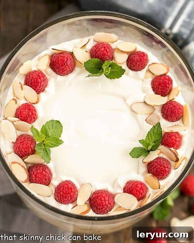 Overhead view of English trifle in a glass trifle bowl, revealing symmetrical layers.