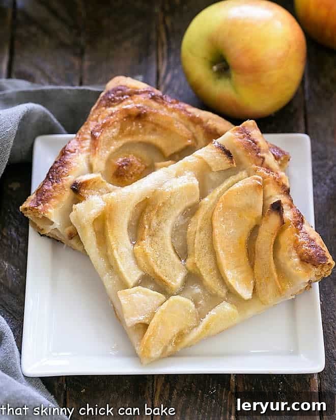 Easy, buttery French Apple Tart with Puff Pastry, sliced and served on a dessert plate, highlighting its flaky crust and tender apples.