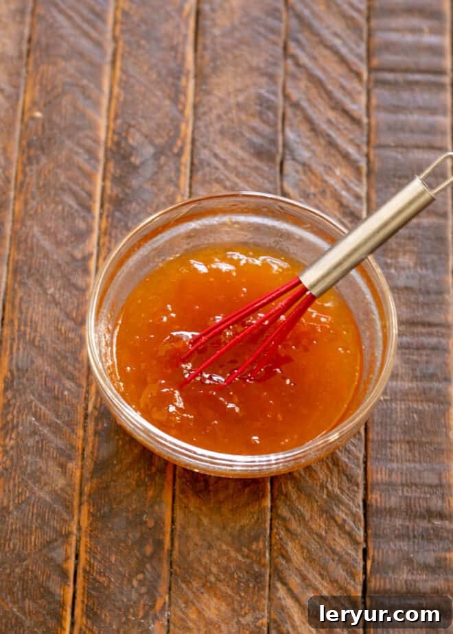 Small saucepan heating apricot jelly and brandy for the tart glaze.