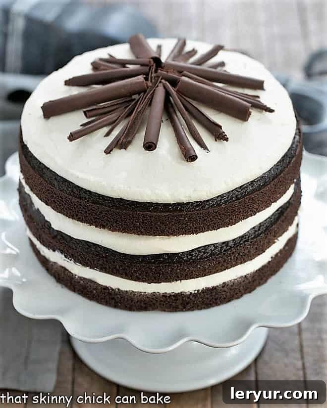 Triple Chocolate Layer Cake on a white cake stand