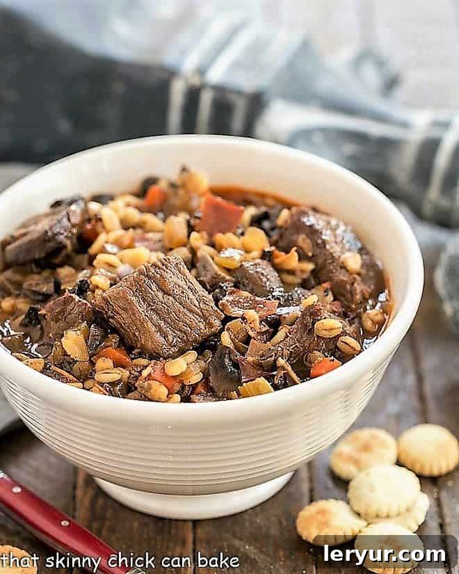 Hearty Beef Mushroom and Barley Soup 2 A steaming bowl of Beef Mushroom Soup with Barley, served with a side of oyster crackers, ready to be enjoyed.