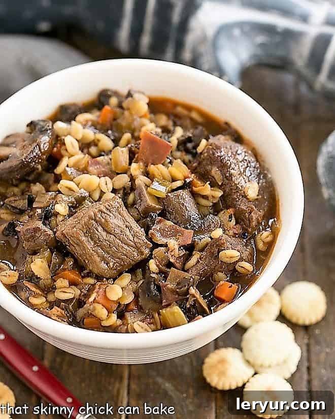 Hearty Beef Mushroom and Barley Soup 4 An overhead shot showcasing a bowl of hearty Beef and Barley Soup, garnished with fresh herbs, emphasizing its rustic appeal and comforting nature.