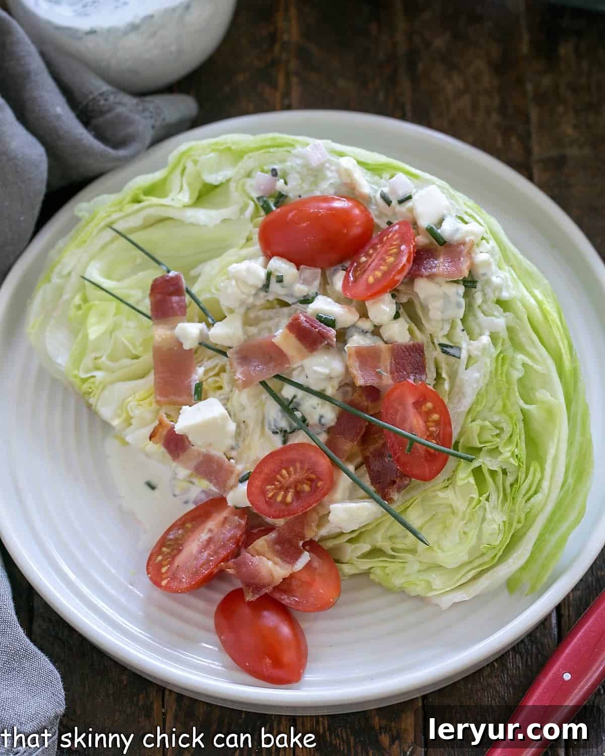 Overhead of Iceberg lettuce wedge salad with homemade blue cheese salad dressing, fresh toppings, and a vibrant presentation.