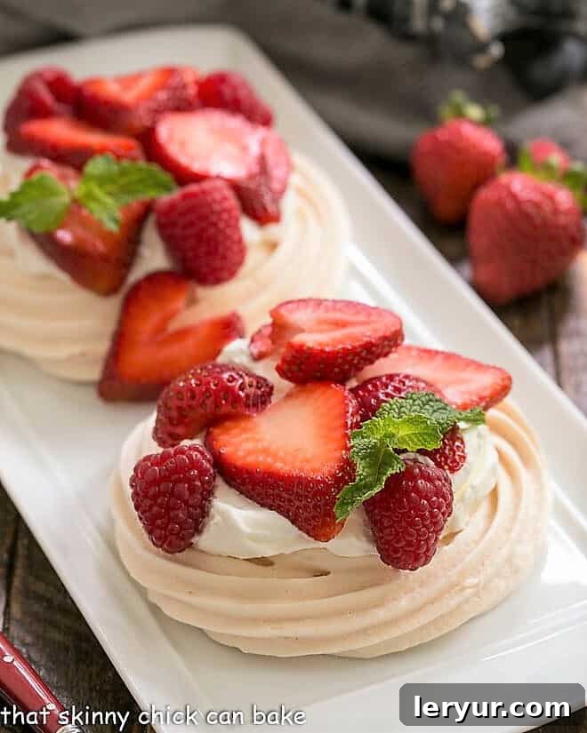 Two individual pavlovas on a white tray