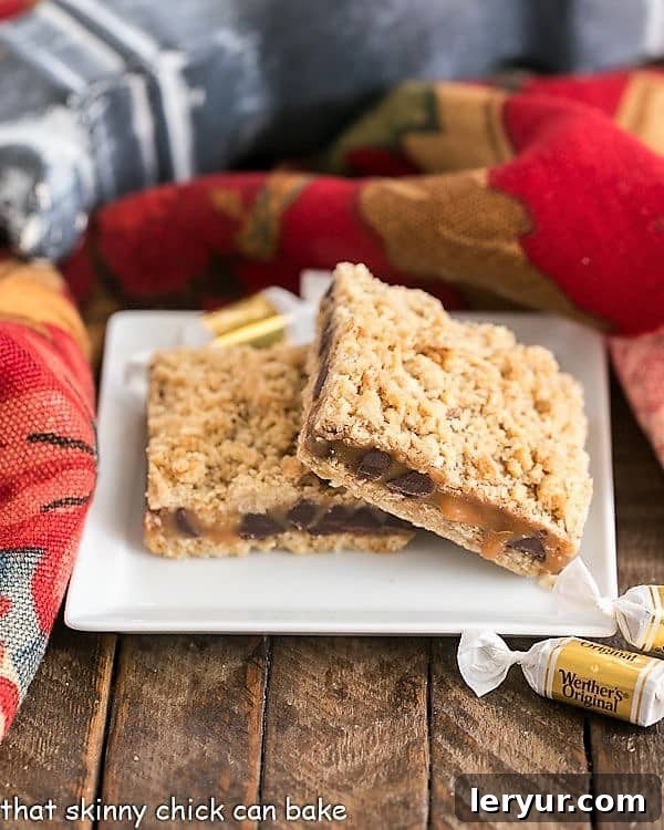 Oatmeal Caramel Bars have an oat crust and oat streusel sandwiching a gooey layer of both caramel and chocolate. This easy oat bars recipe with caramel makes the perfect dessert for any occasion! #caramel #dessert #oatmeal 2 Oatmeal Caramel Bars stacked on a square dessert plate