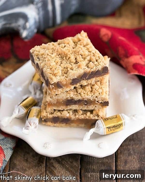 Oatmeal Caramel Bars have an oat crust and oat streusel sandwiching a gooey layer of both caramel and chocolate. This easy oat bars recipe with caramel makes the perfect dessert for any occasion! #caramel #dessert #oatmeal white dessert plate with a stack of 3 Oatmeal Caramel Bars