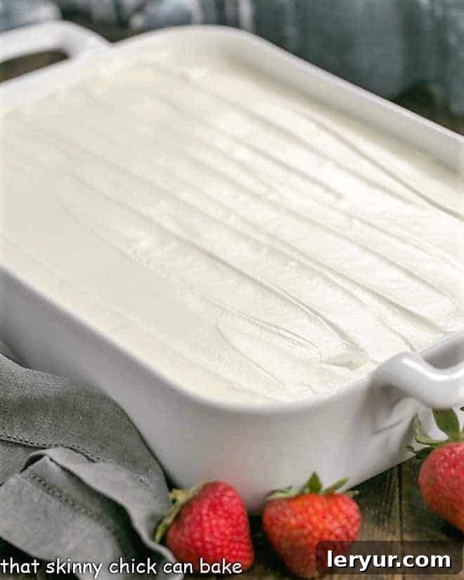 Authentic Tres Leches Cake - A Latin American favorite make with 3 milks, a homemade sponge cake and whipped cream frosting! Authentic Tres Leches Cake in a ceramic 9 x 13 pan.