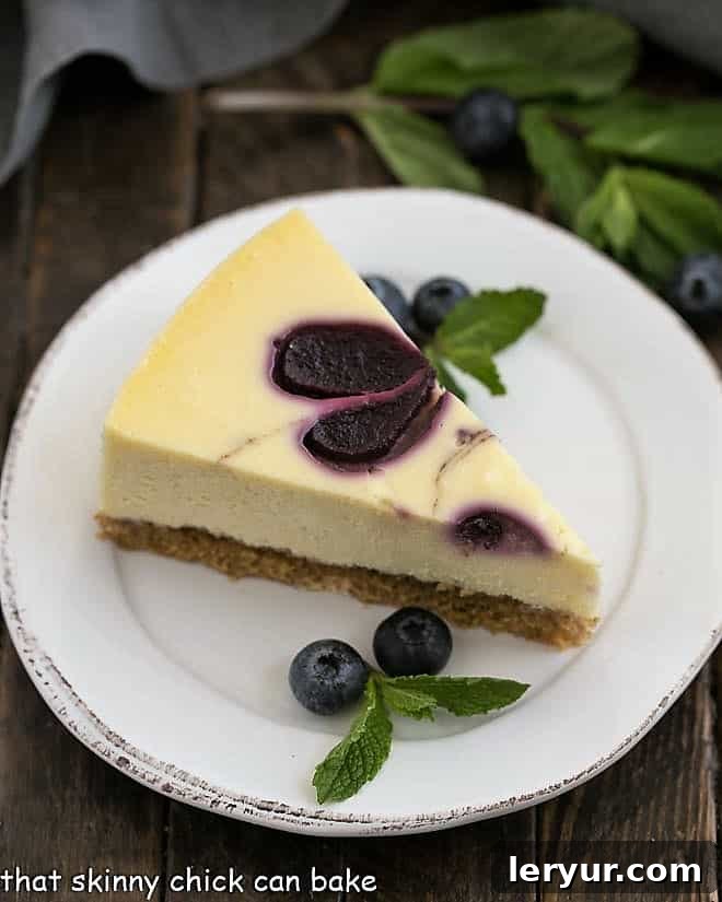 Velvet Blueberry Swirl Cheesecake 2 A stunning Blueberry Swirl Cheesecake with a golden-brown crust and vibrant blue swirls, ready to be sliced.