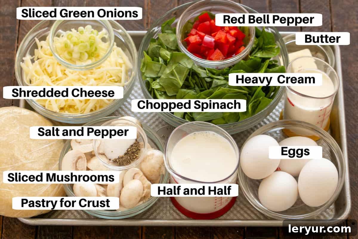 Garden & Woodland Quiche 2 A metal sheet pan displaying all the fresh ingredients needed for Spinach Quiche, including baby spinach, sliced mushrooms, eggs, cheese, half and half, heavy cream, and red bell pepper, each clearly labeled.