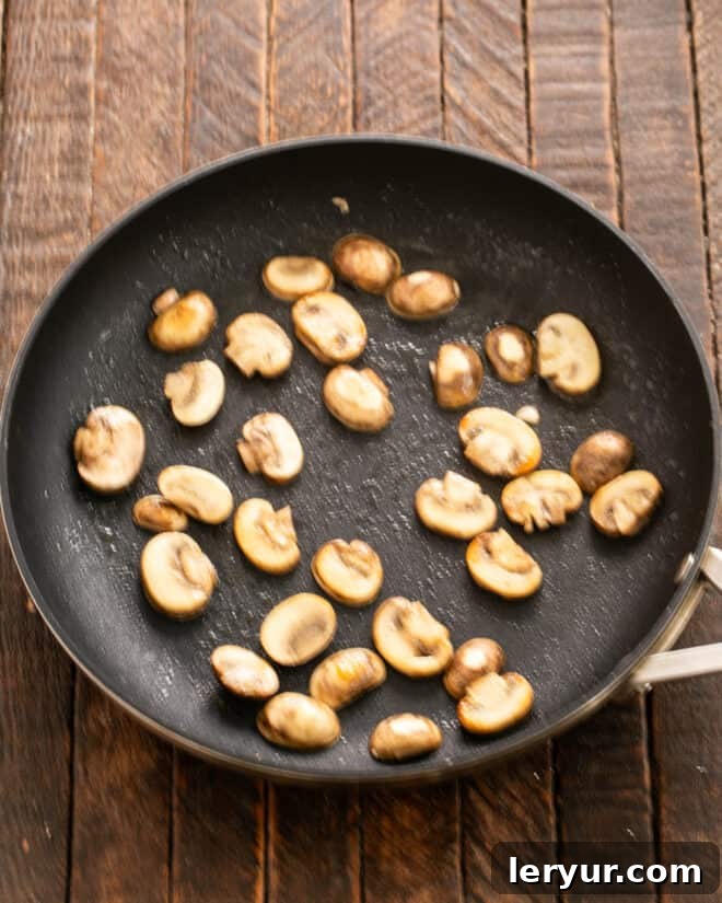 Garden & Woodland Quiche 3 Mushrooms sautéing in a hot skillet with butter until tender and golden brown.