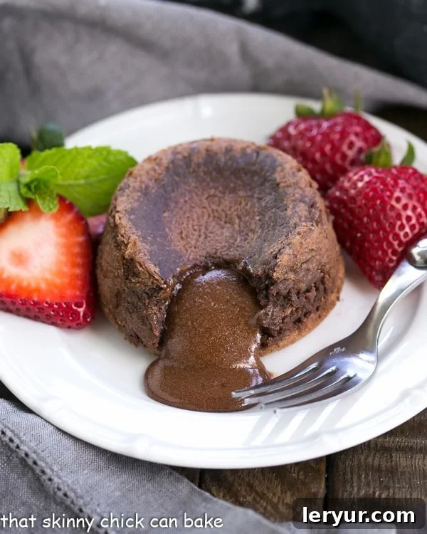 Classic Chocolate Lava Cake with Strawberries Decadent molten lava cake oozing rich chocolate, garnished with fresh, vibrant strawberries