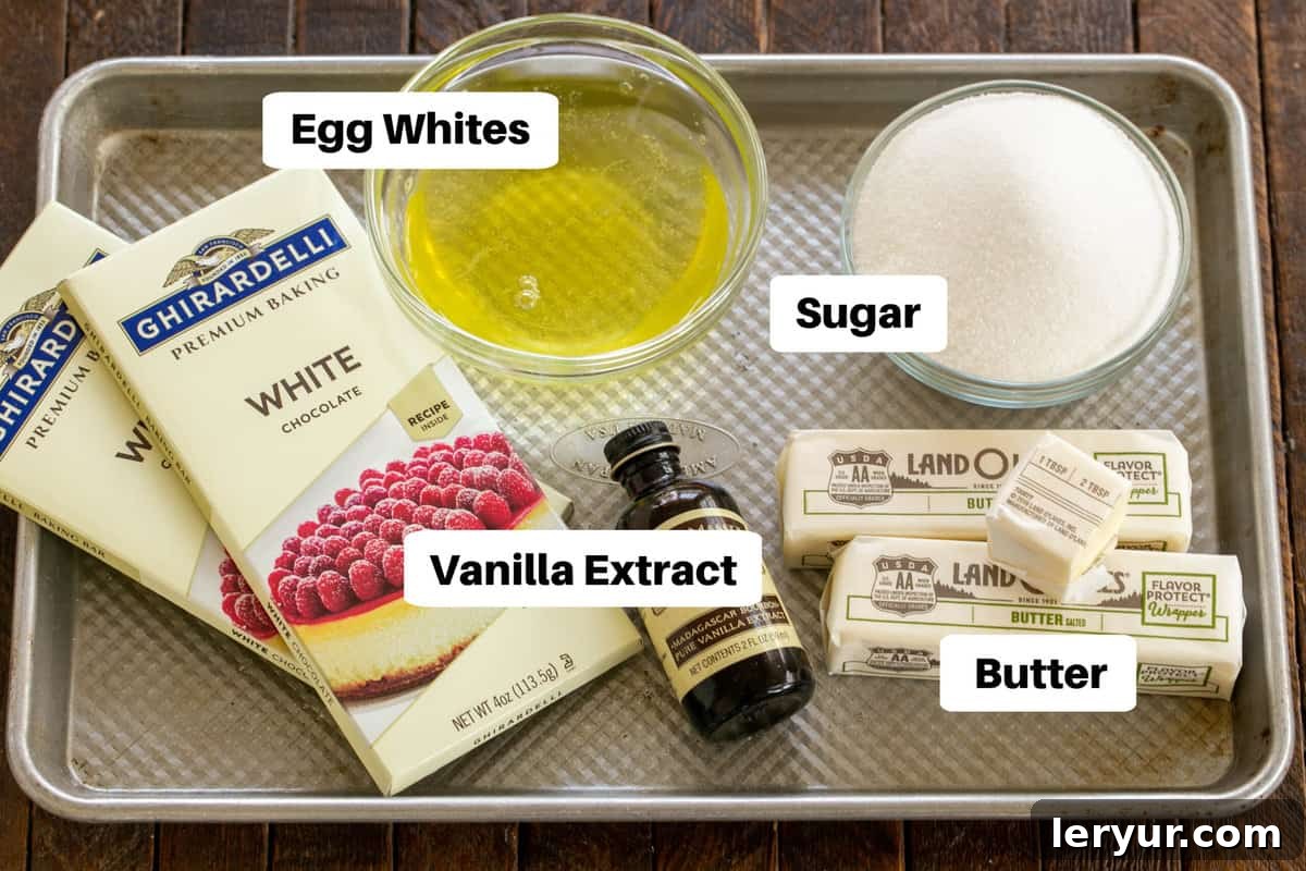 All the essential components for the White Chocolate Swiss Meringue Buttercream, neatly laid out on a sheet pan with labels, ready for preparation.