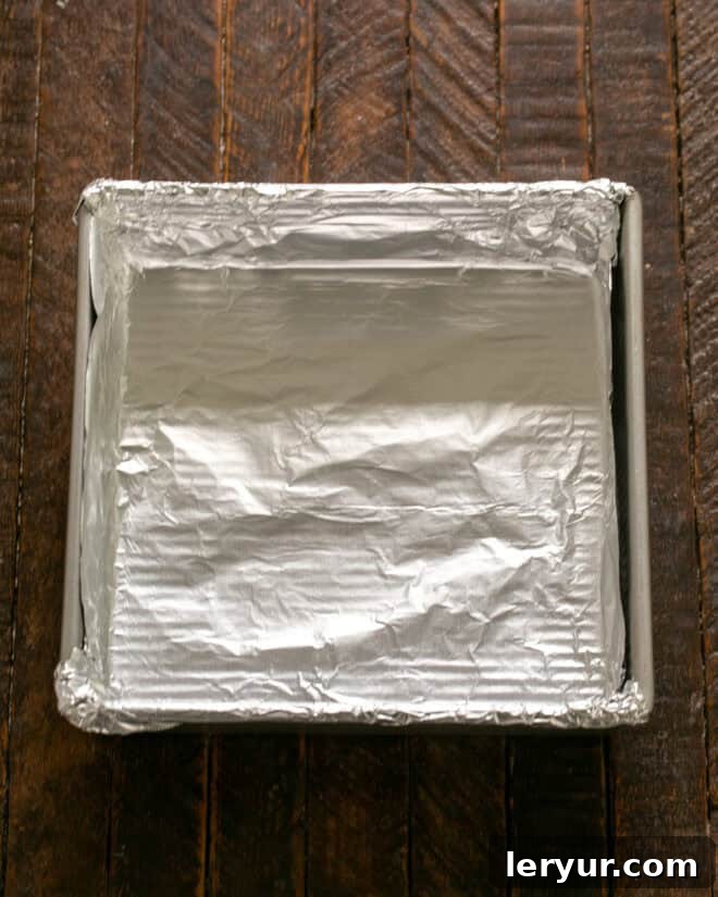 Forget Reeses: These Are The Best Peanut Butter Bars 3 Baking pan lined with nonstick foil, ready for the peanut butter mixture.