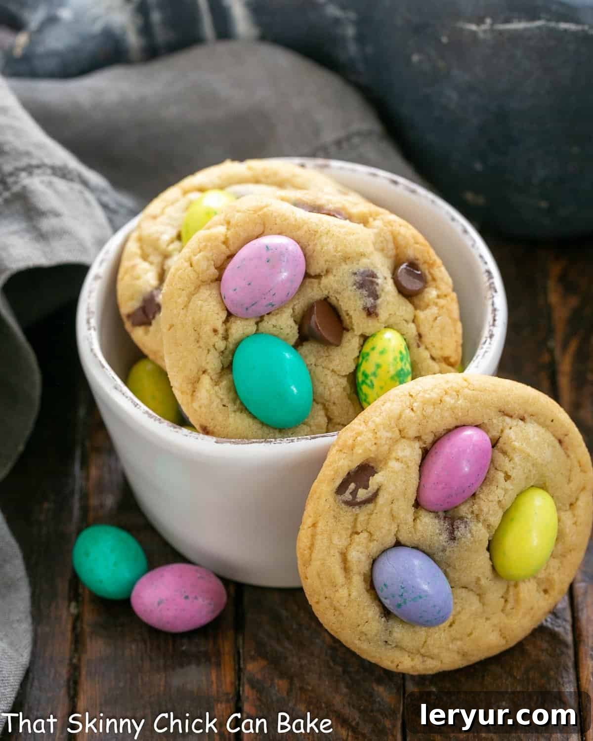 Easter cookies in a white bowl with one leaning on the bowl.