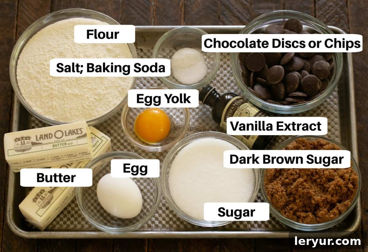 Divine Brown Butter Chocolate Chip Cookies 2 All the essential ingredients for Brown Butter Chocolate Chip Cookies laid out on a sheet pan, including butter, sugars, eggs, flour, and chocolate, with clear labels for easy identification.