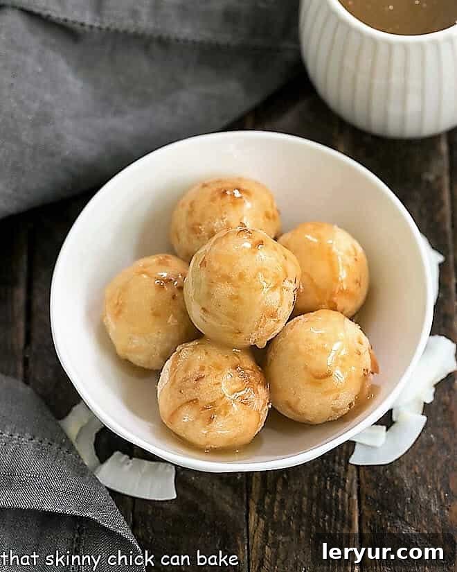 Fried Sticky Rice Balls in a white serving bowl, glistening with caramel sauce