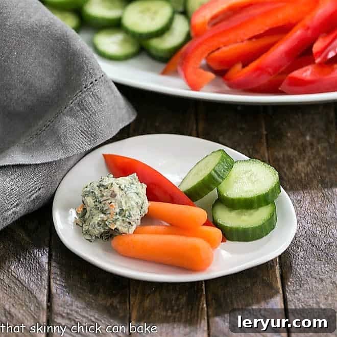 Sour Cream Spinach Dip on a small white plate with crudite