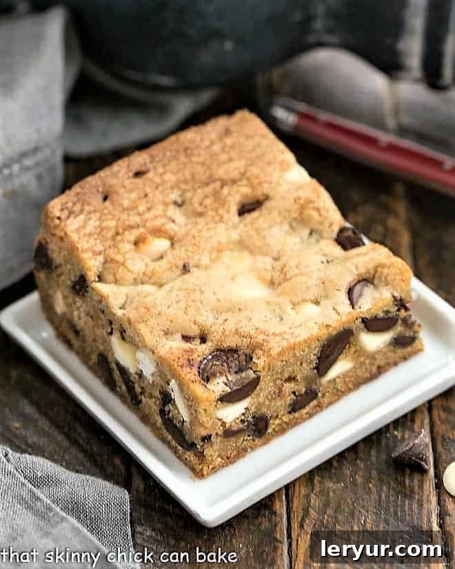 A tray of perfectly baked chocolate chip cookie bars, cooled and neatly sliced into uniform squares, ready to be served and enjoyed.