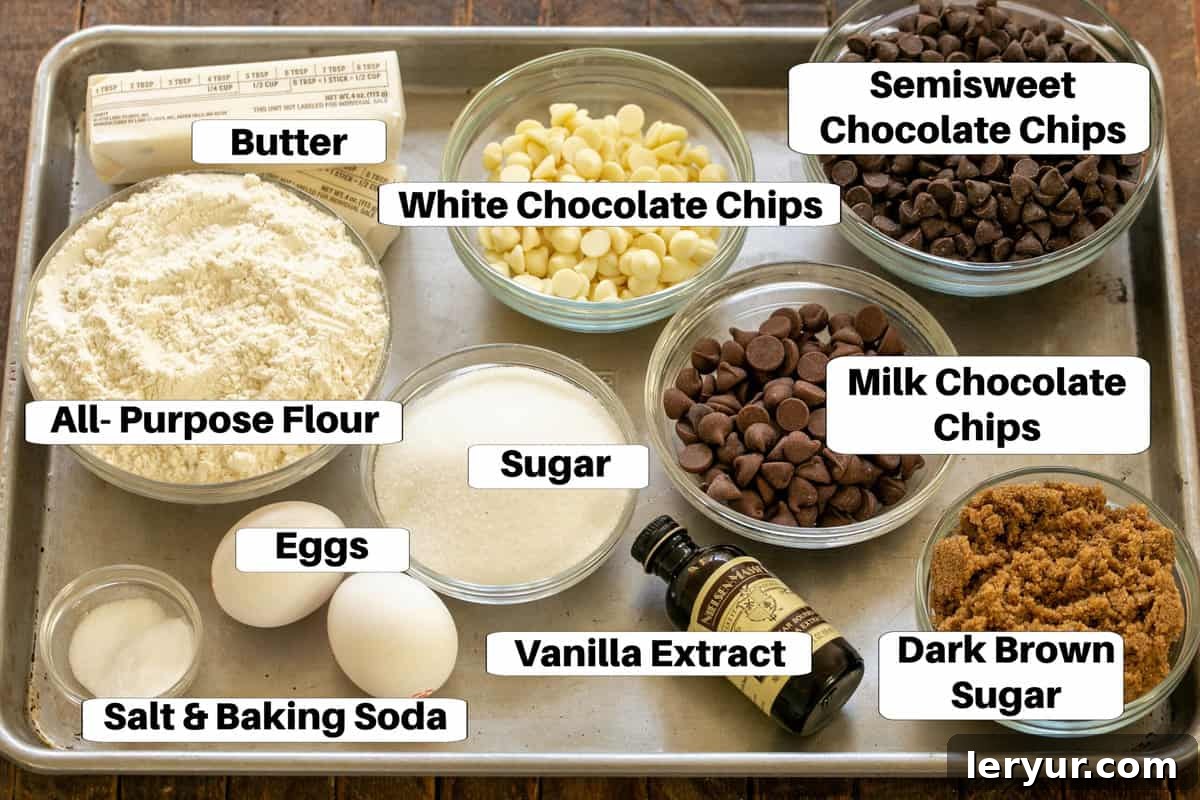 A perfectly arranged display of essential Chocolate Chip Bars ingredients on a sleek metal sheet pan, complete with clear labels for each item.