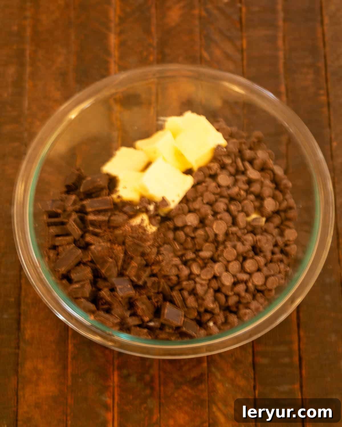 Step 1: Butter, chocolate chips, and chopped unsweetened chocolate in a heatproof bowl.