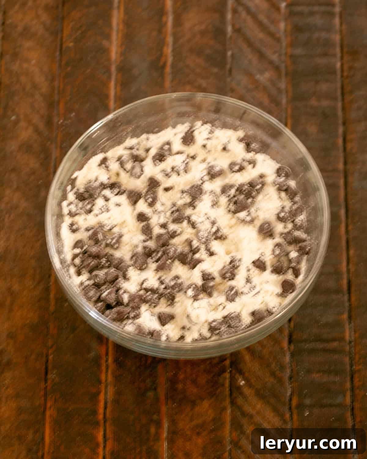 Step 6: Adding the remaining chocolate chips to the flour mixture.