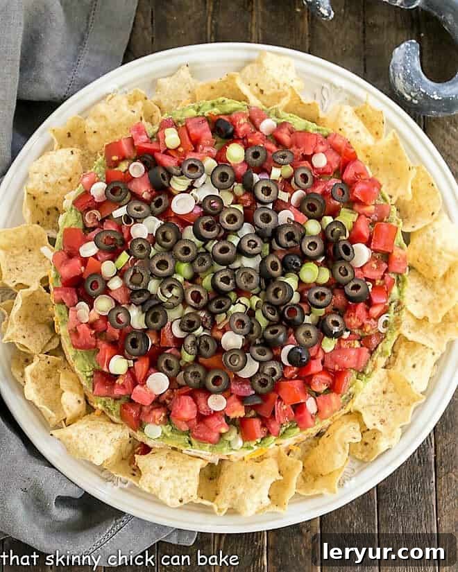 Overhead view of Layered Taco Dip surrounded by tortilla chips