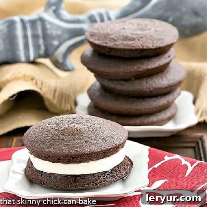 Chocolate Whoopie Pies - The ultimate Whoopie Pies recipe featuring an exquisite marshmallow cream filling that's truly magical. Classic Chocolate Whoopie Pies elegantly arranged on white dessert plates, showcasing their rich color and creamy filling.
