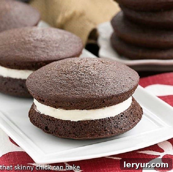 Maine Whoopie Pies - The definitive recipe for Whoopie Pies, featuring an exquisite and fluffy marshmallow cream filling. A selection of Classic Whoopie Pies artfully arranged on a pristine white ceramic serving tray, highlighting their perfect form and inviting appearance.