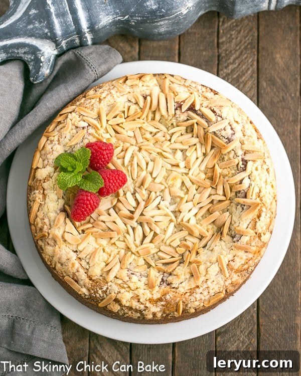 Raspberry Cream Cheese Coffe Cake - Perfect for that special breakfast or brunch! Overhead view of a whole Raspberry Cream Cheese Coffee Cake, generously topped with slivered almonds and streusel, ready to be served.