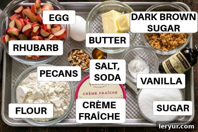 All the essential ingredients for Rhubarb Baby Cakes, meticulously labeled and arranged on a sheetpan, ready for baking.
