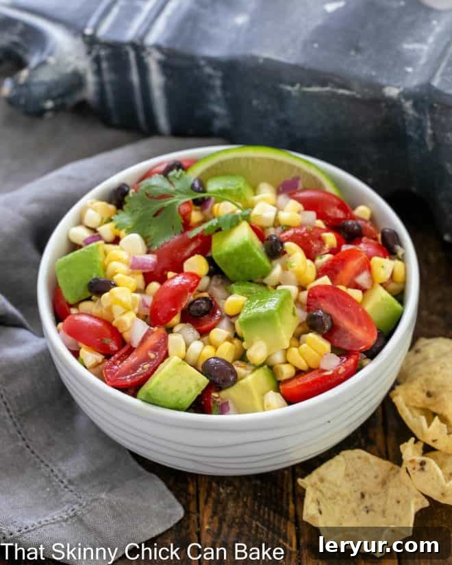 Vibrant Black Bean Avocado Corn Salsa 4 Corn salsa recipe in a white ceramic serving bowl with a cilantro garnish