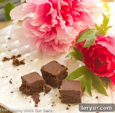 A nearly empty platter of Refrigerator Brownies with some pink peonies
