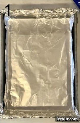 Blackberry Cheesecake Bliss Bars 2 A 9x13 inch baking pan prepared with nonstick foil for cheesecake bars.